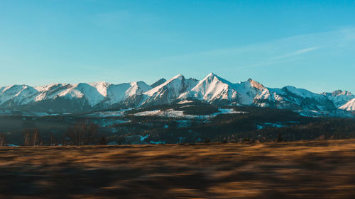 Scenic view of snowcapped mountains against sky