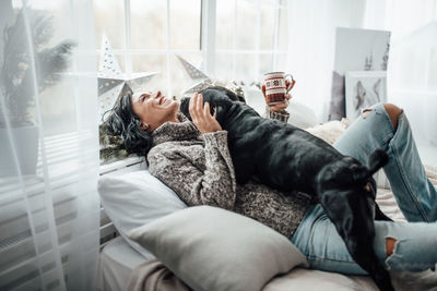 Woman lying on sofa at home