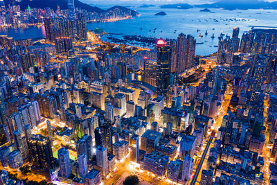 Aerial view of buildings in city against sky at dusk