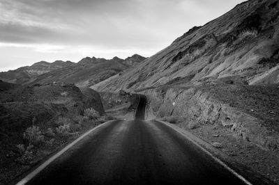 Country road amidst rocky mountains