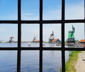 View of sea against sky seen through window