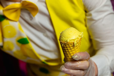 Midsection of man holding ice cream cone