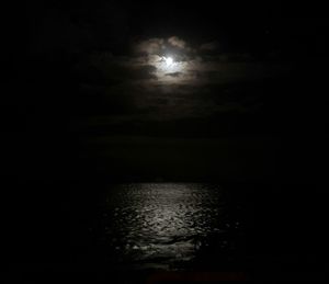 Scenic view of sea against sky at night