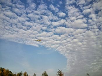 Low angle view of airplane flying in sky