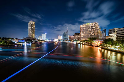 High angle view of light trails on chao phraya river in city at night