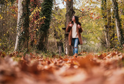 Rear view of woman walking in forest