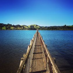 Road passing through a blue sky