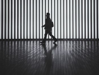 Full length of silhouette man walking in passage