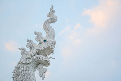 Low angle view of statue against sky