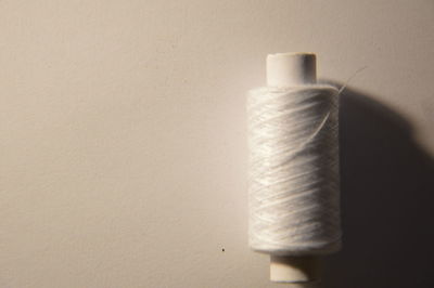 Close-up of electric lamp on table against wall