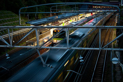 High angle view of light trails on bridge at night