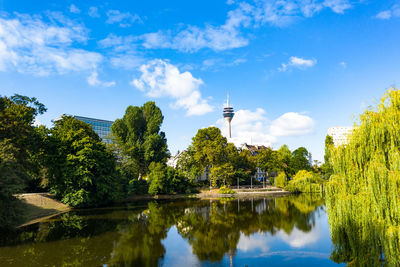 Scenic view of lake by buildings against sky