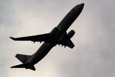 Low angle view of airplane flying in sky