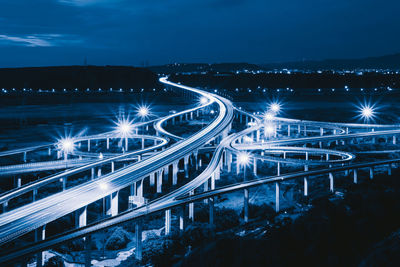 High angle view of illuminated bridge against sky at night