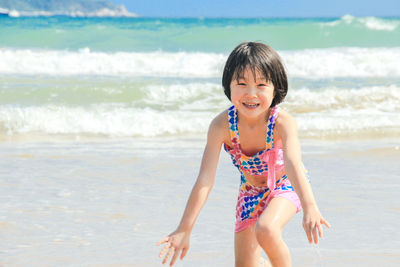 Full length of happy girl on beach