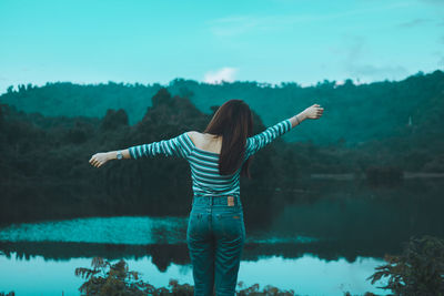 Rear view of woman standing in water