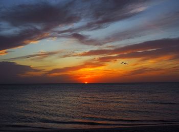 Scenic view of sea against orange sky