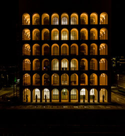 Illuminated building against sky at night