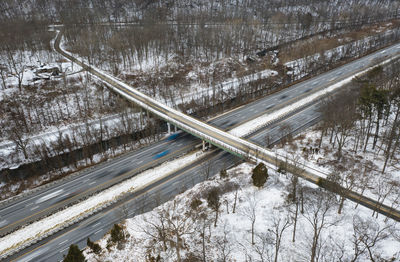 High angle view of snow covered road by trees