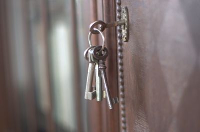 Close-up of keys hanging on door