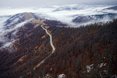 High angle view of snowcapped mountains against sky