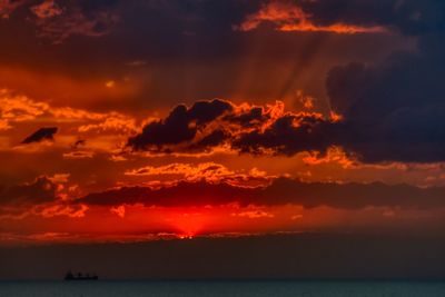 Scenic view of dramatic sky over sea during sunset