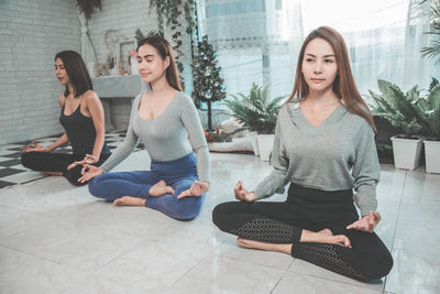 Beautiful young woman sitting on floor