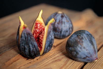 Fresh cut purple figs on a wooden background from old boards. raw exotic figs.