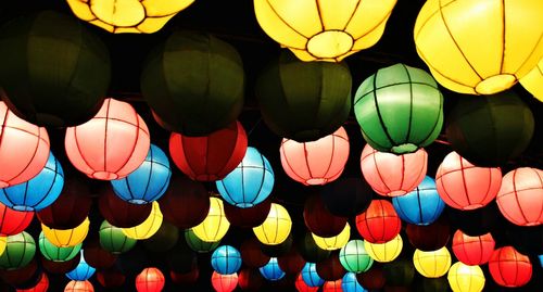 Low angle view of illuminated lanterns hanging at night