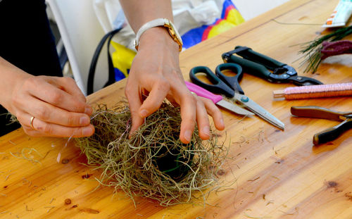 Midsection of person making nest