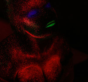 Woman with eyes closed in neon make-up