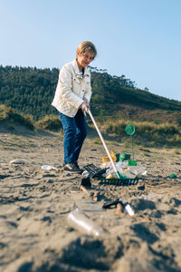 Man holding umbrella while standing on land