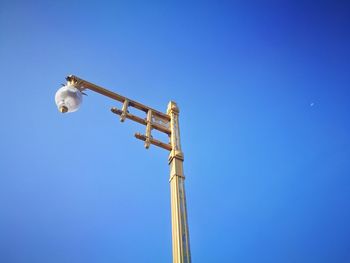 Low angle view of crane against clear sky