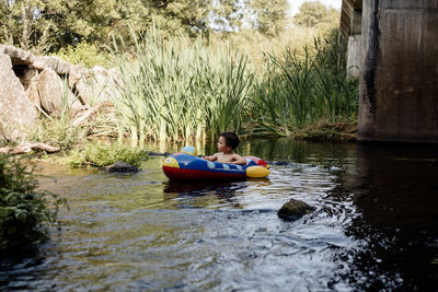 Child playing with inflatable boat