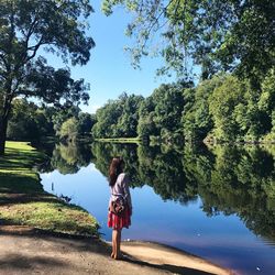 Full length of woman standing by lake