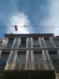 Low angle view of building against cloudy sky