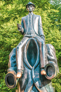 Close-up of statue against plants in park