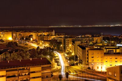 High angle view of illuminated buildings in city at night