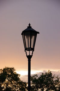Silhouette street light against sky during sunset