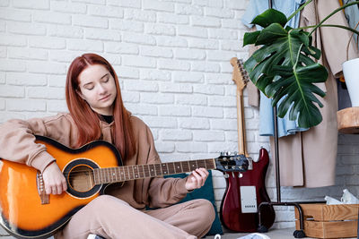 Young woman playing guitar