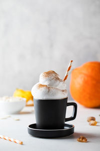 Spicy pumpkin latte with whipped cream and cinnamon. autumn drinks.