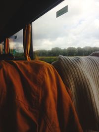 Scenic view of field against sky seen through window