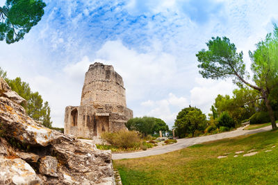 Ruins of temple against cloudy sky