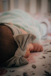 Midsection of child sleeping on bed