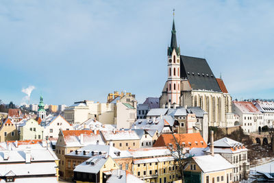 Buildings in town against sky