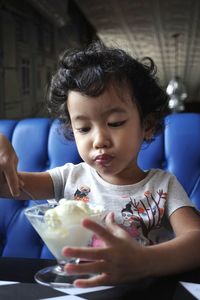 Cute baby girl sitting in restaurant