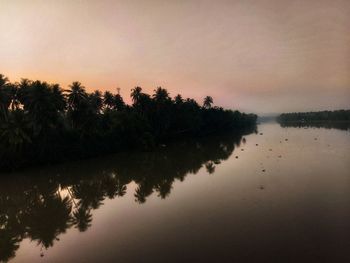 Scenic view of lake against sky during sunset