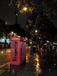 Illuminated street lights in city at night