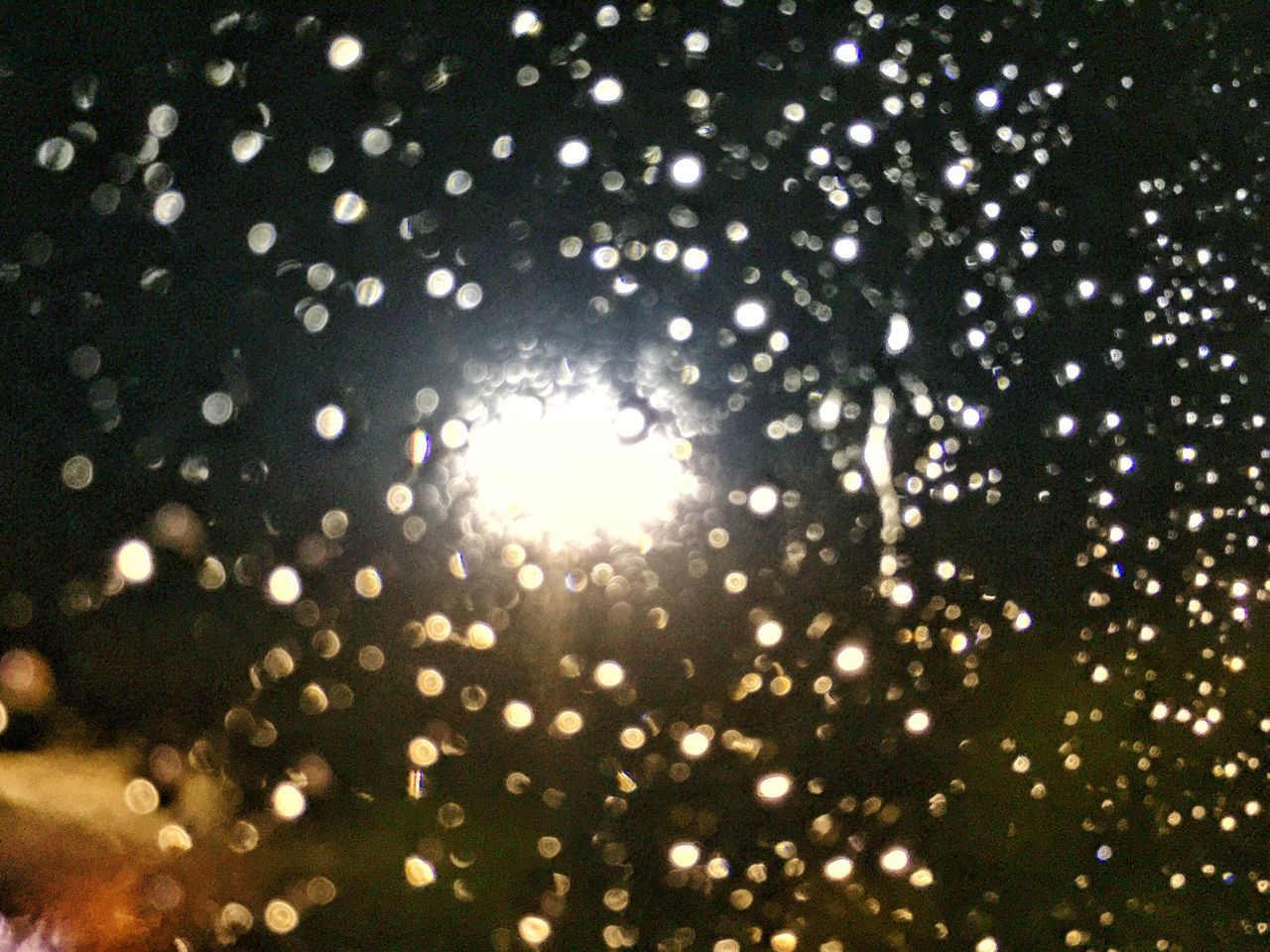 CLOSE-UP OF ILLUMINATED LIGHTS AGAINST SKY