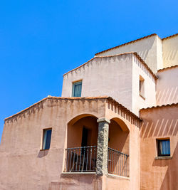 Low angle view of old building against clear blue sky